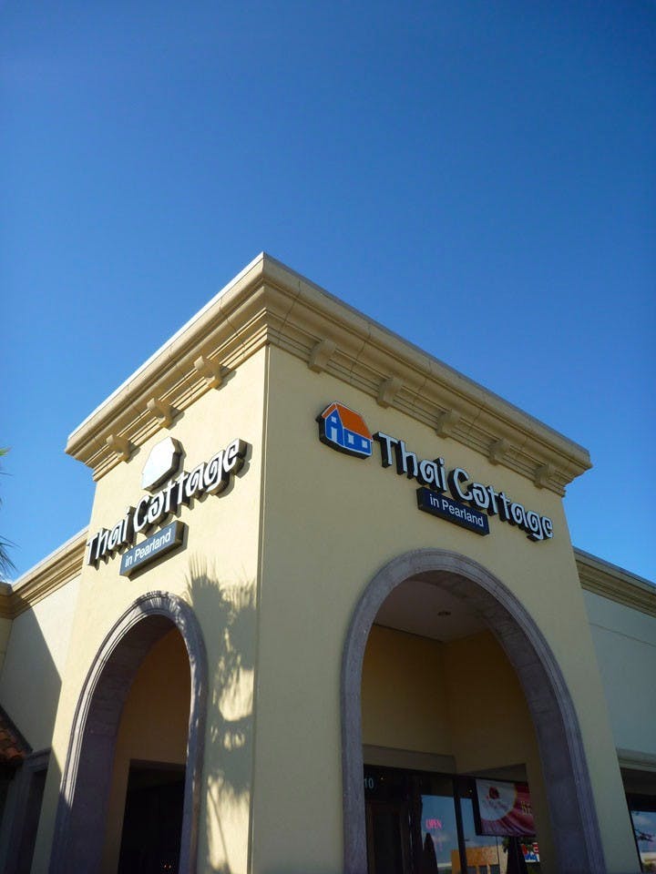 a clock looking tower displaying the restaurants name