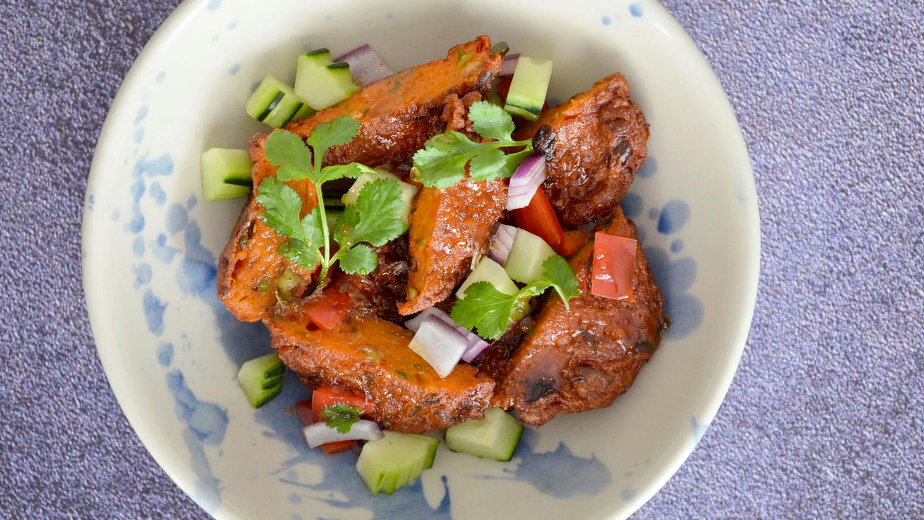 a white plate topped with meat and vegetables