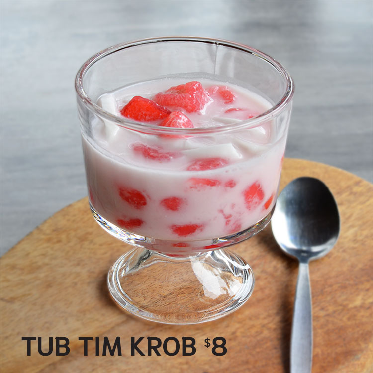 a glass of yogurt with strawberries and milk