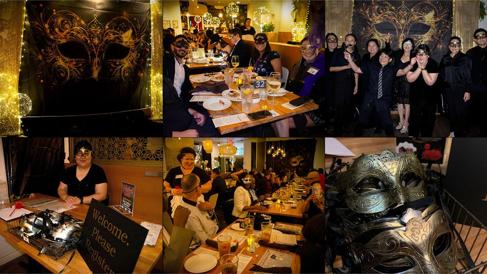 a group of people sitting at a table posing for the camera