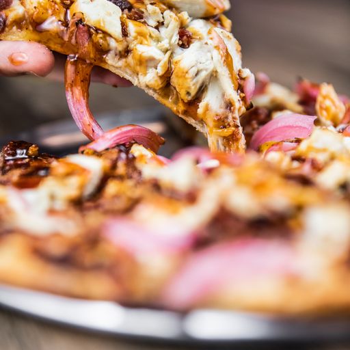 a close up of a slice of bbq chicken pizza