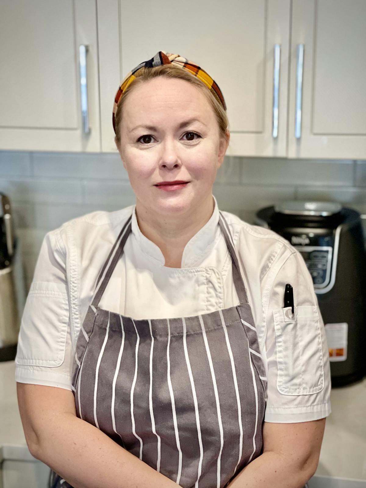 a woman standing in a kitchen