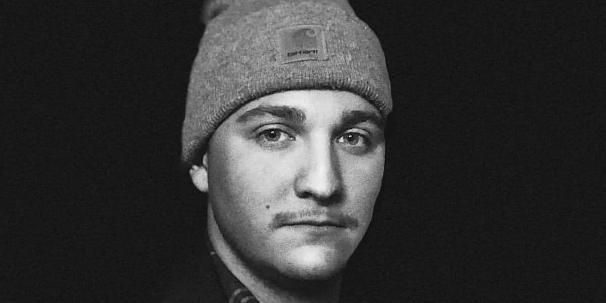 a man wearing a hat posing for the camera