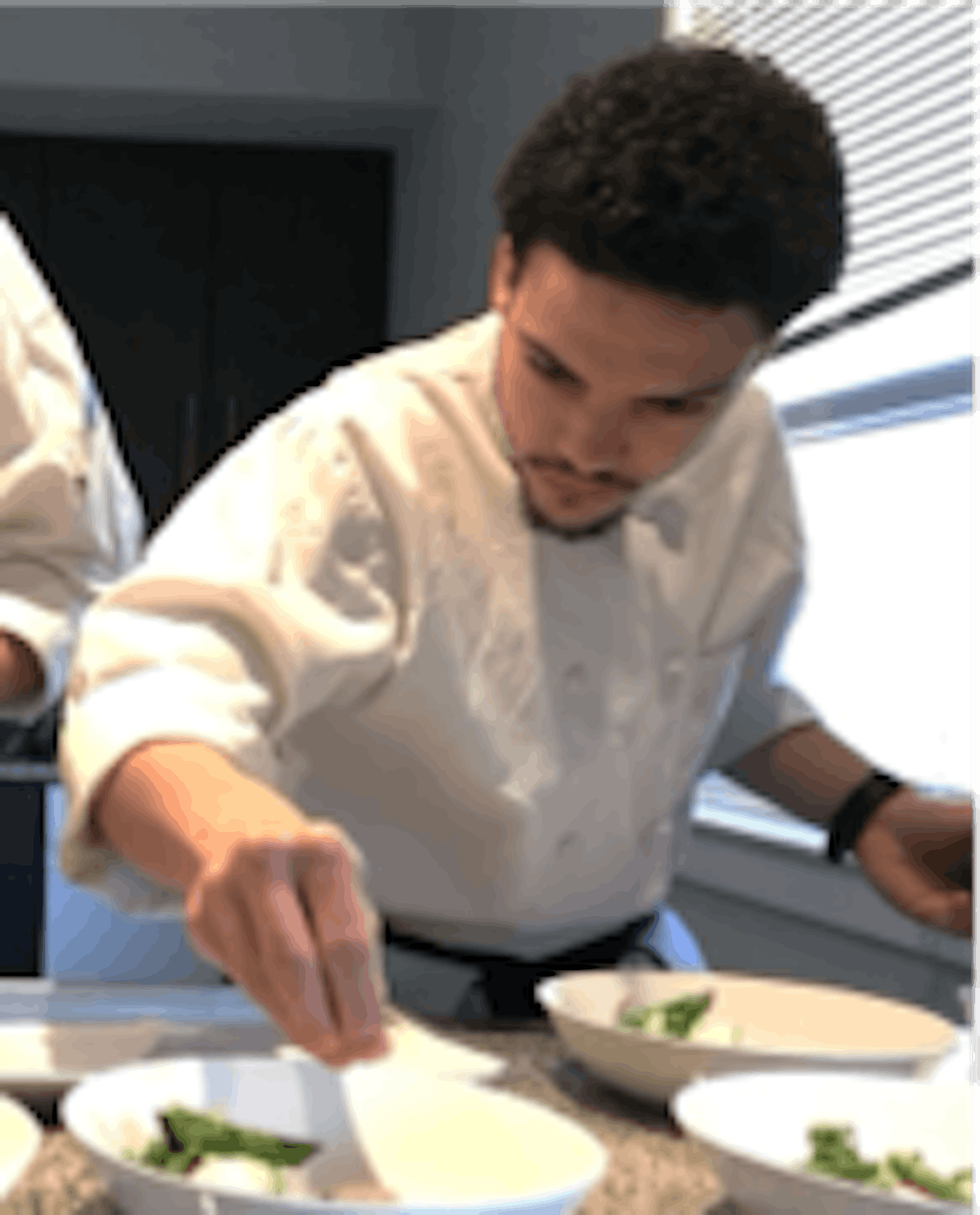 a man preparing food in a kitchen