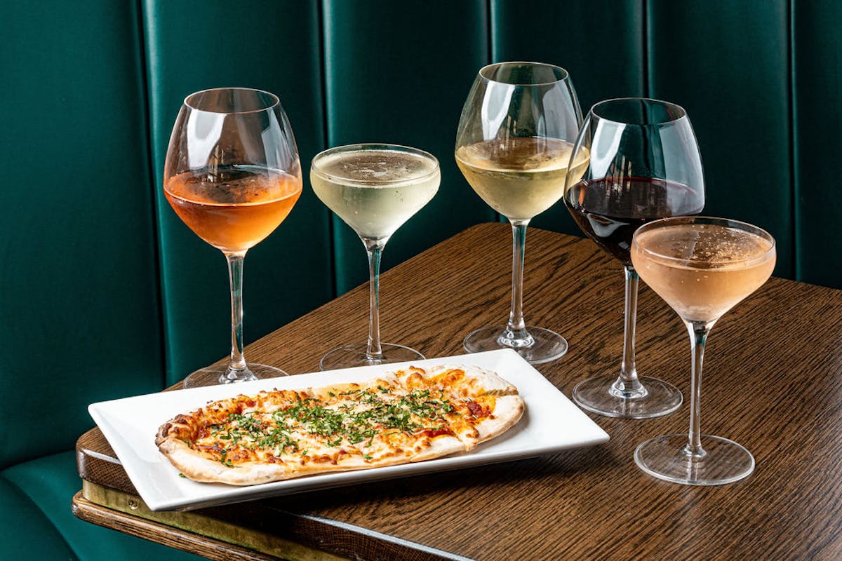 a plate of food and a glass of wine