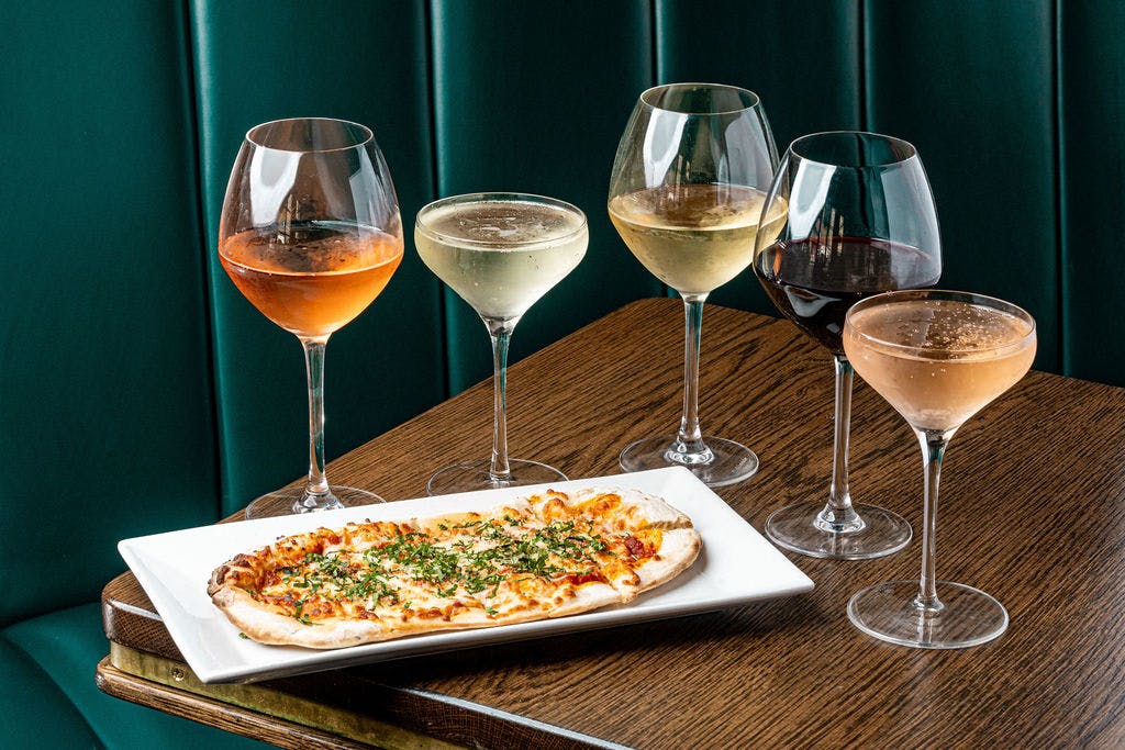 a plate of food and a glass of wine