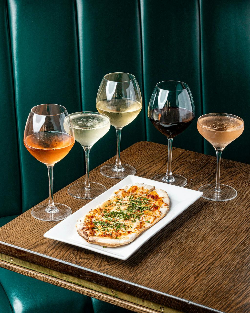 a plate of food and a glass of wine