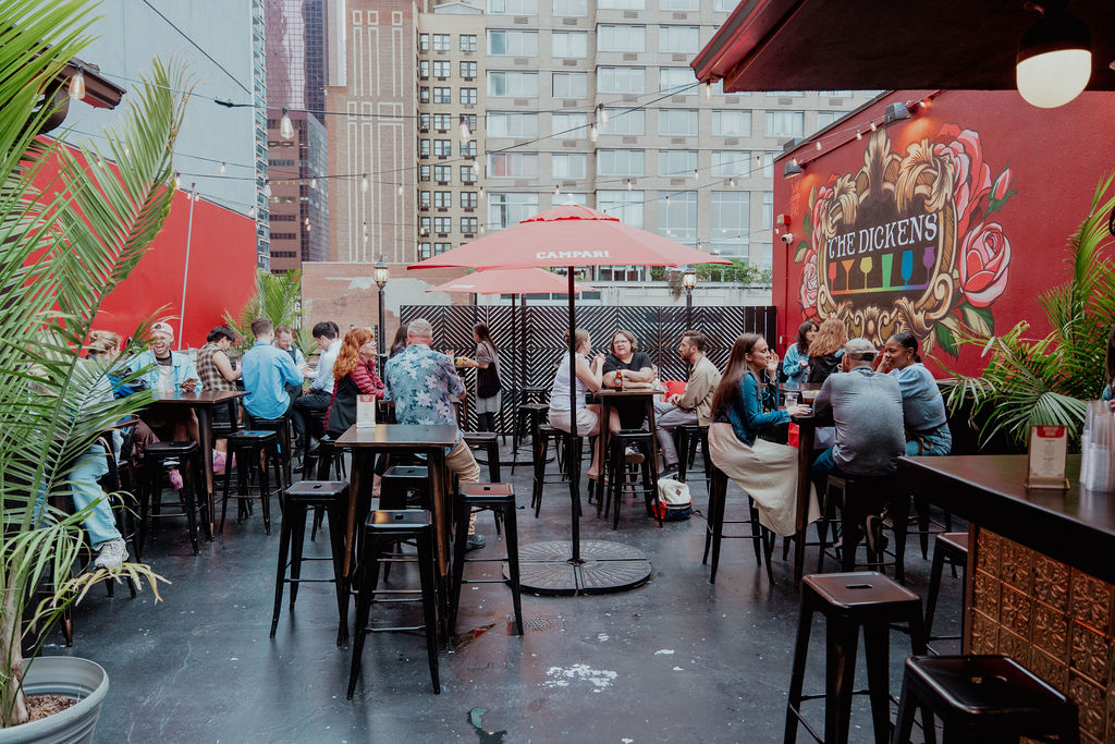 a group of people sitting at a table in front of a building