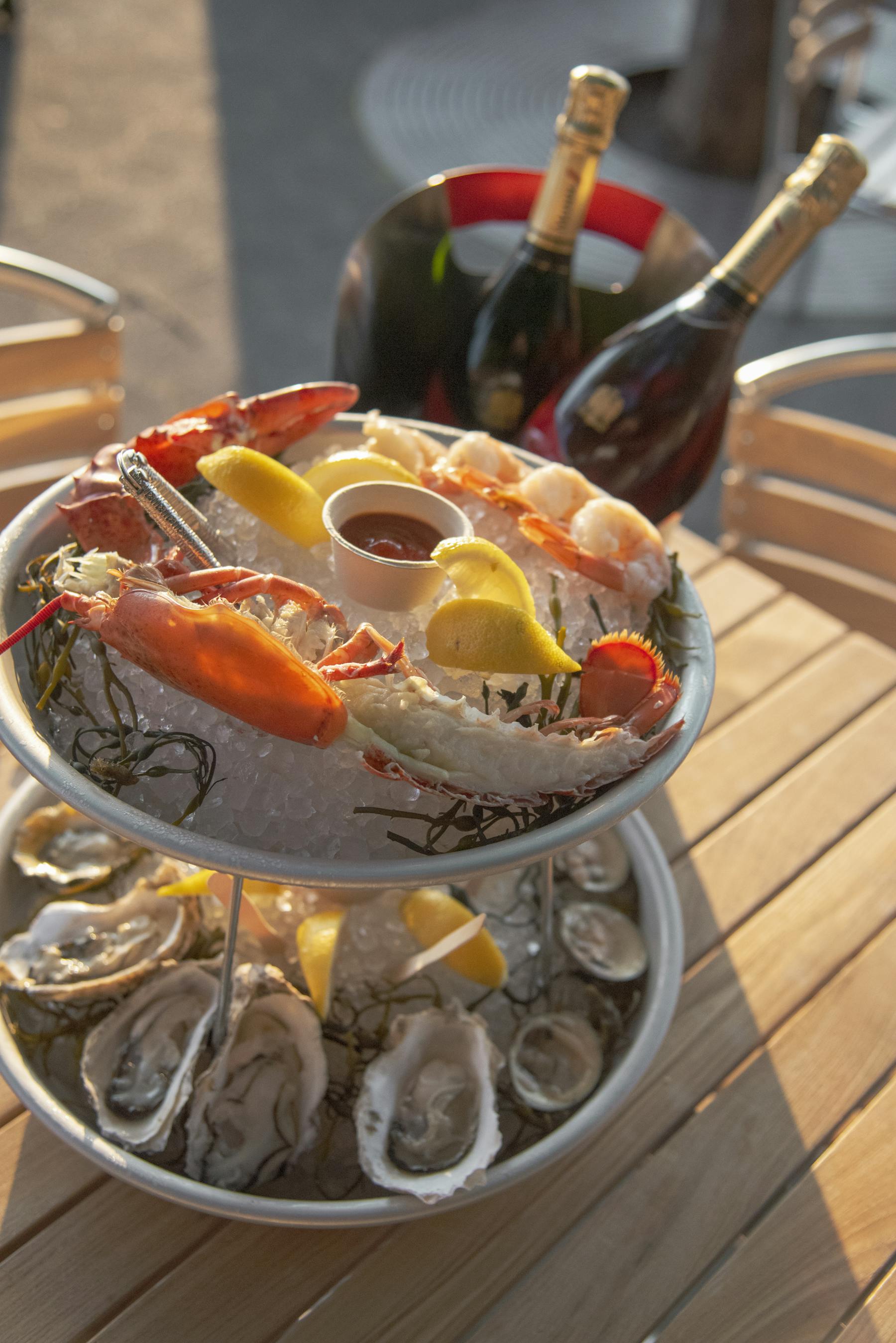 a plate of shrimps on top of a wooden table