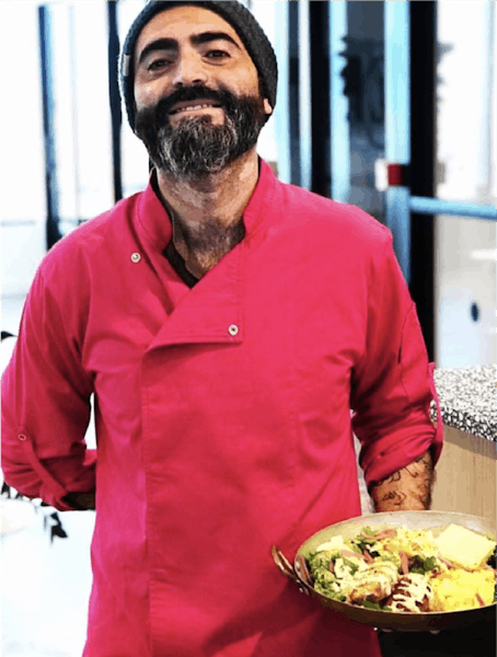 a man standing in front of a plate of food