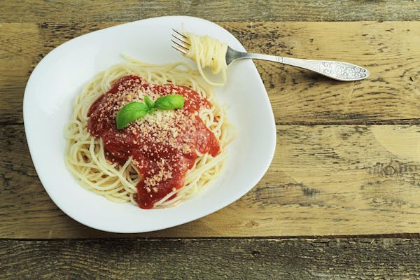 spaghetti served in a white plate