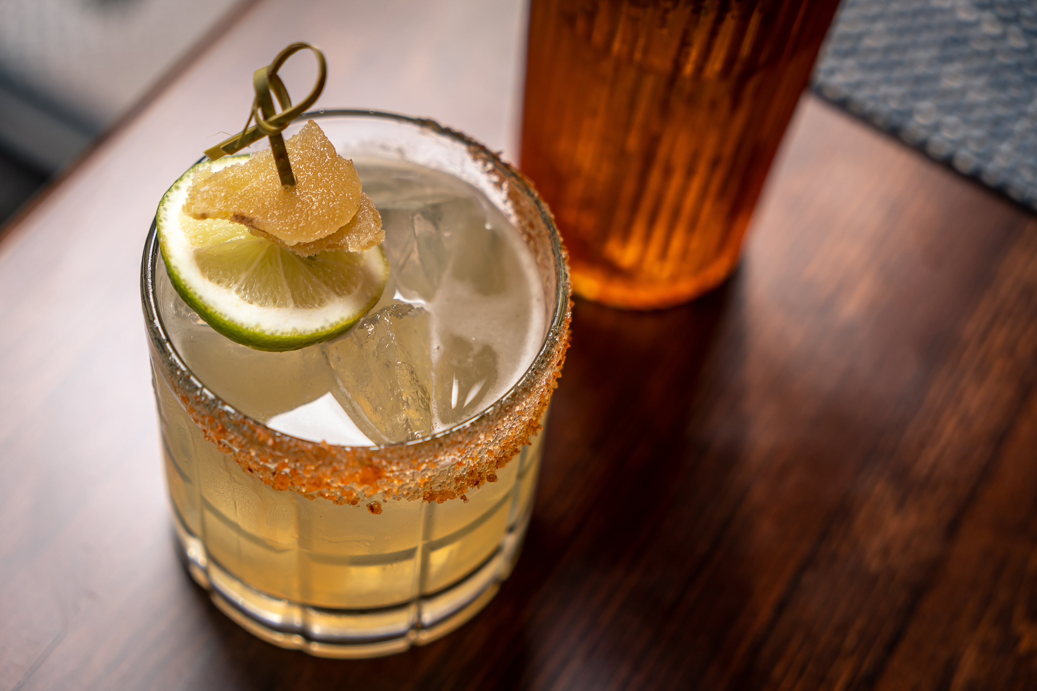 a glass of the Independent's handcrafted Rat Race cocktail on a wooden table