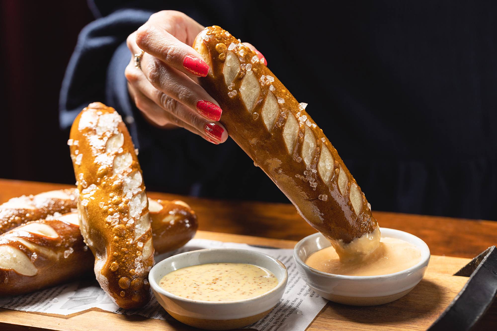 Dipping The Independent's Bavarian Pretzel Sticks into the German beer cheese and spicy whole grain mustard
