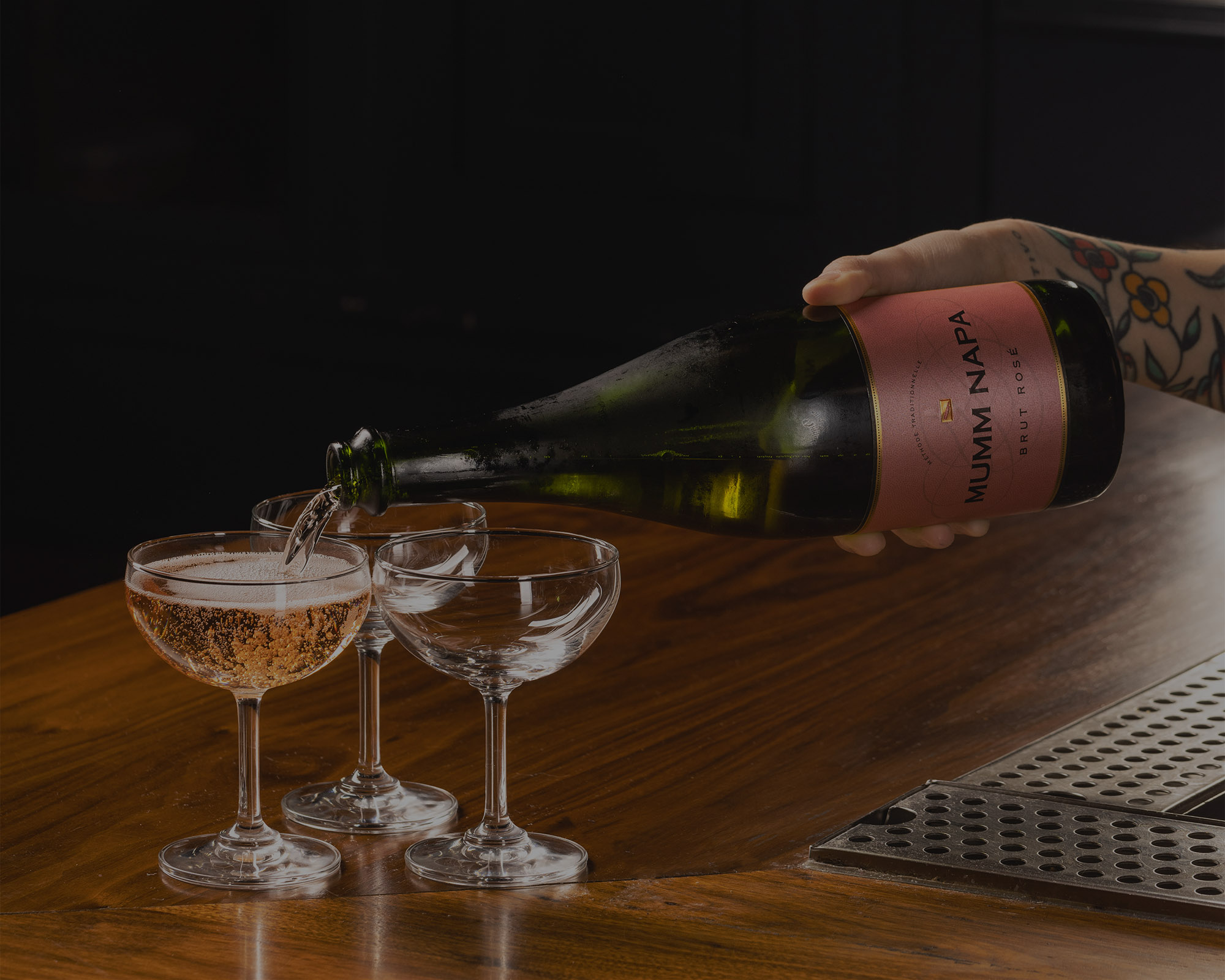 bartender pouring a glass of Mumm Napa Brut Rosé for a celebration at The Independent by the Theatre District and Times Square