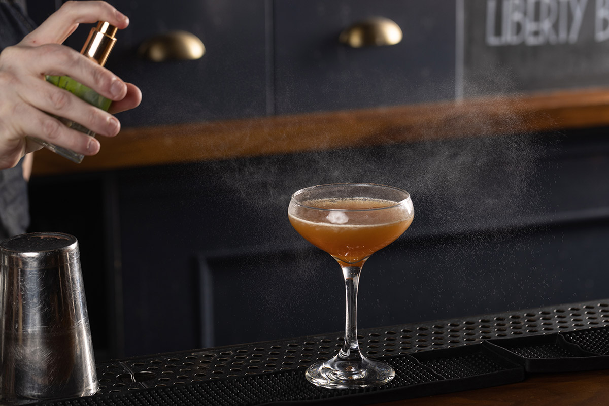 Bartender finishing off The Hudson cocktail from The Independent in Midtown, NYC.