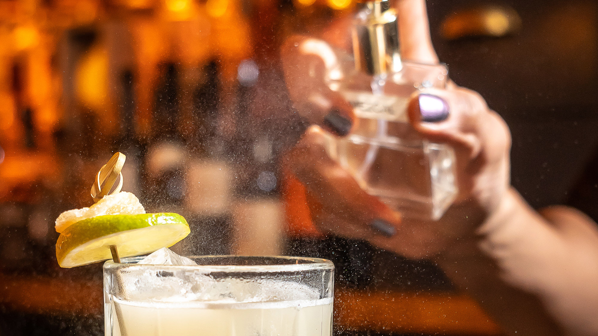 bartender finishing off the Rat Race cocktail with a spritz of mezcal mist on top