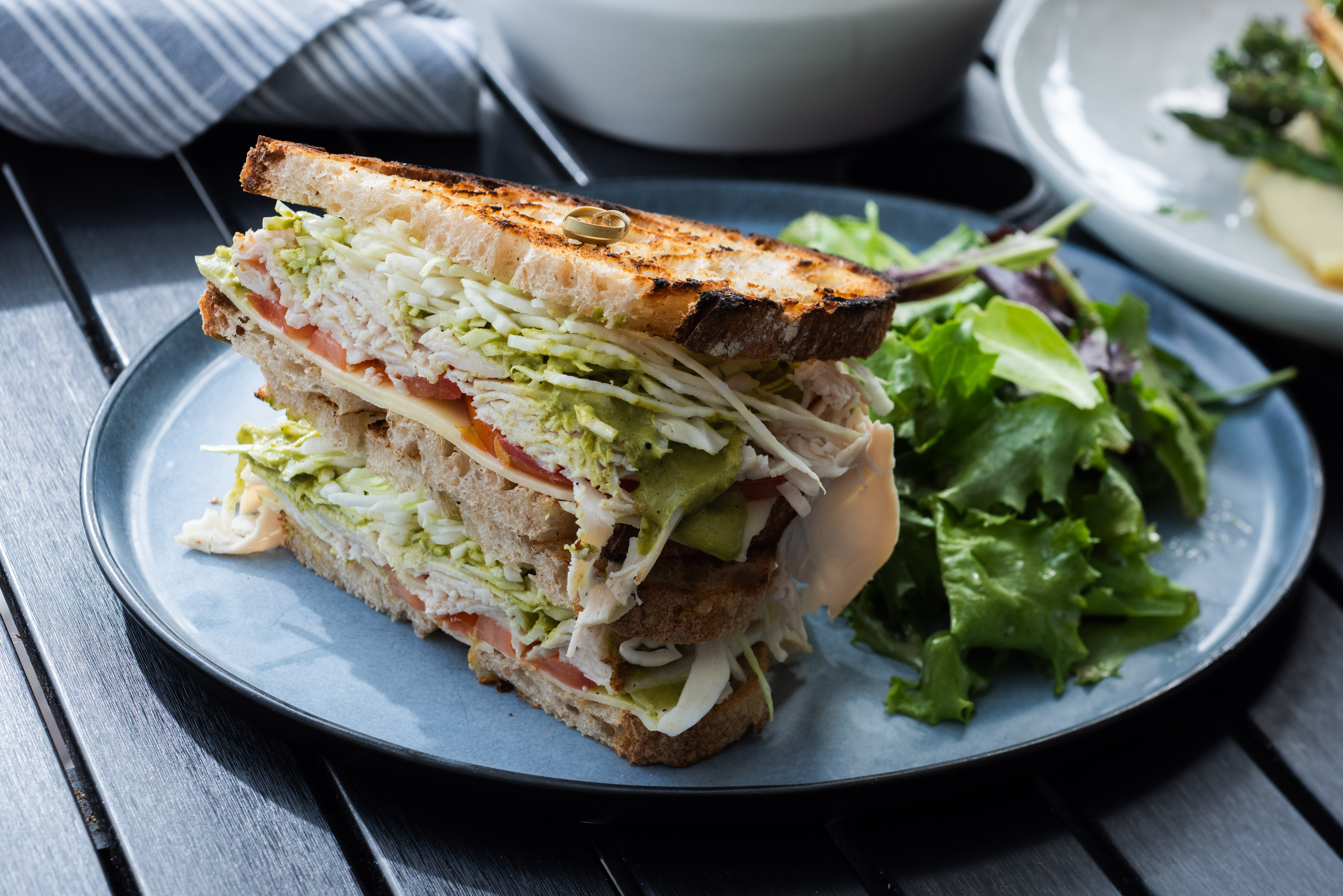 Turkey Malibu with Roasted turkey breast, green goddess, beefsteak tomato, shredded cabbage, gruyere cheese, ciabatta & mixed greens