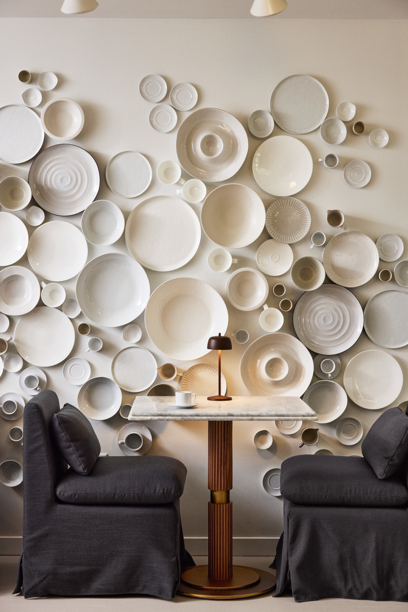 a wall with plates and a table