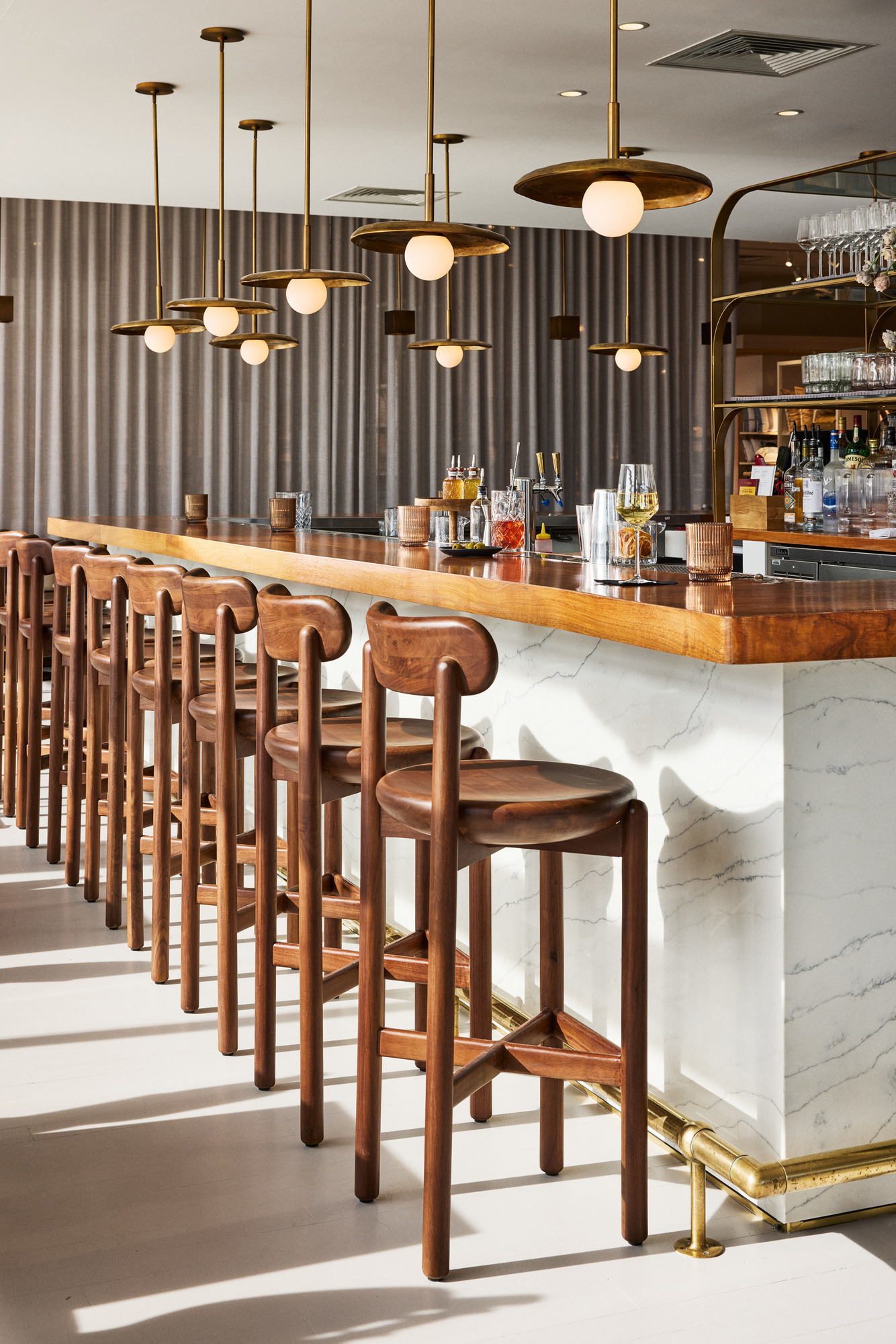a bar with chairs and lights