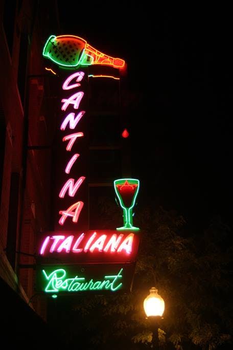 a sign lit up at night