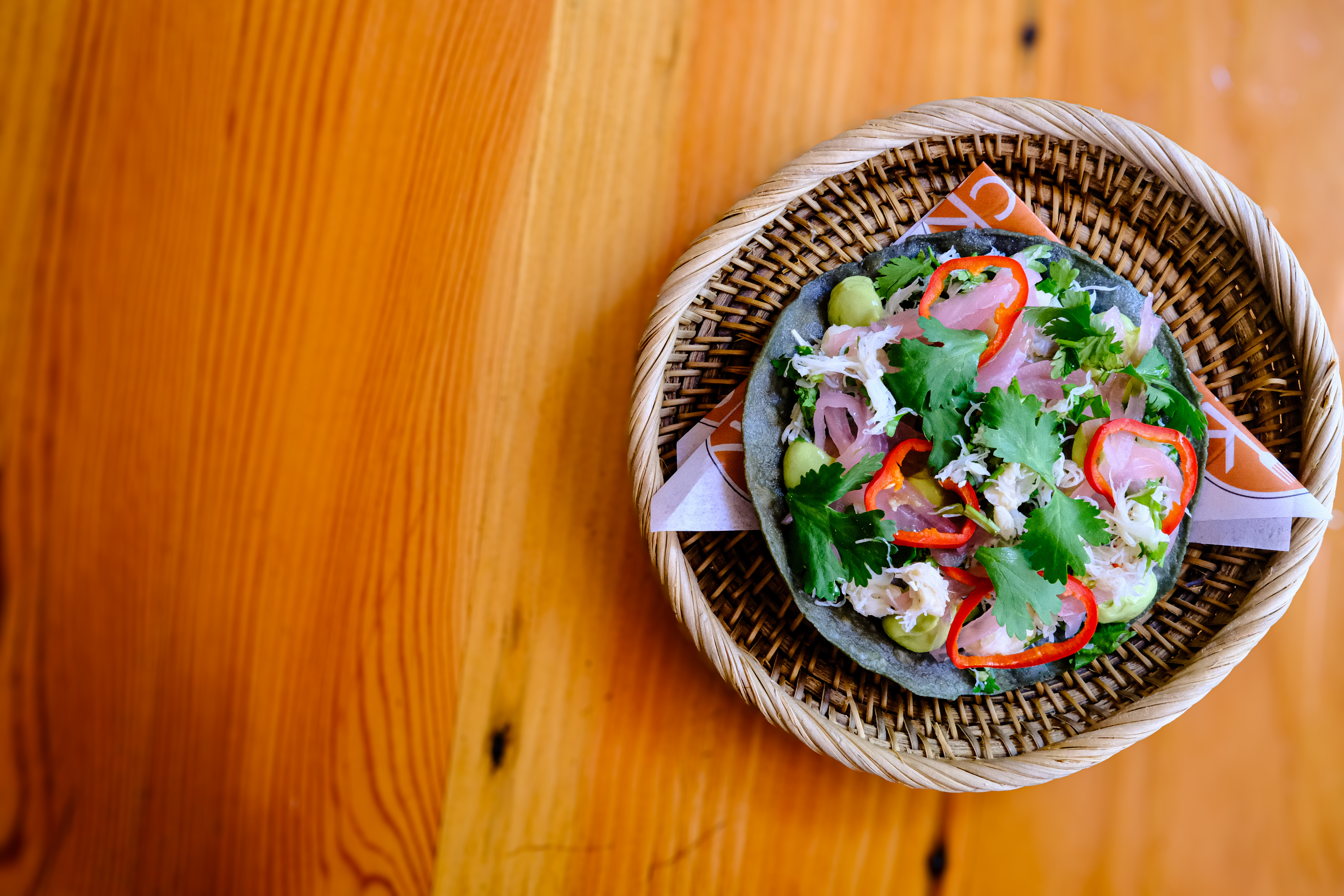 a bowl of food sitting on top of a wooden table