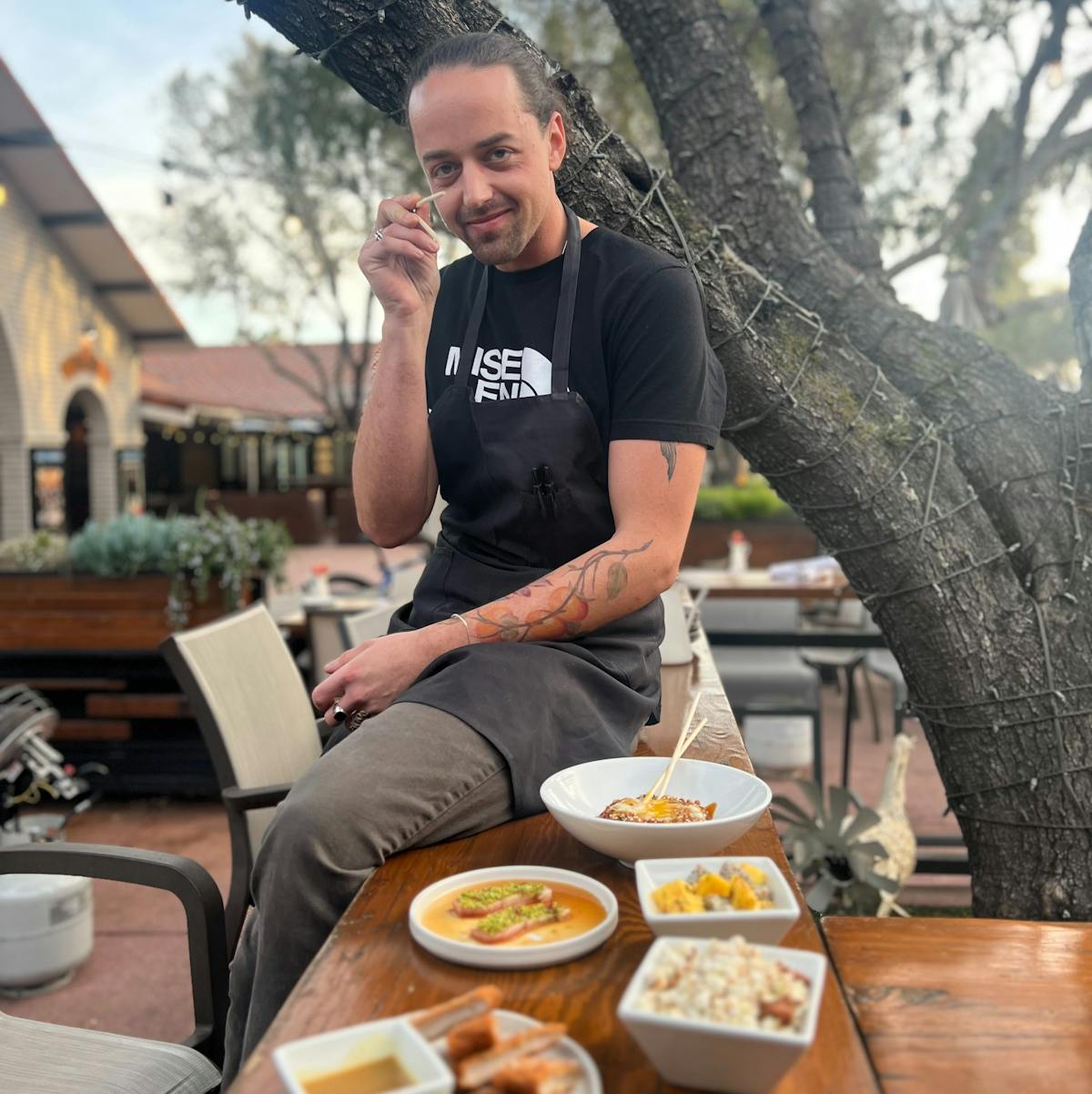 a person sitting at a picnic table
