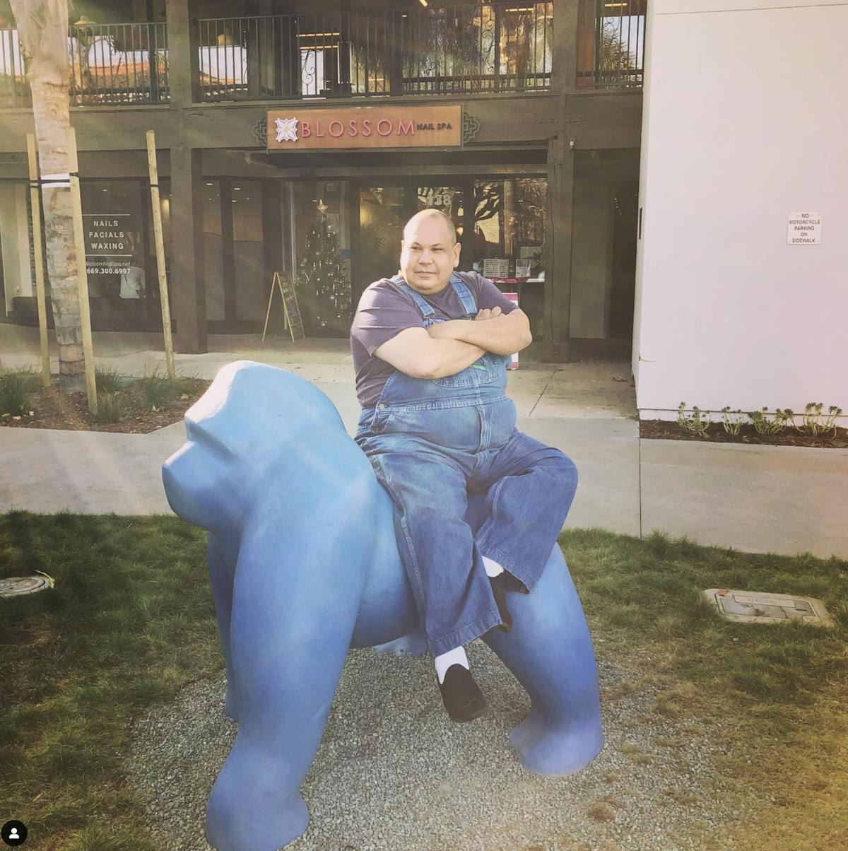 Jeffrey Stout sitting on a bench talking on a cell phone