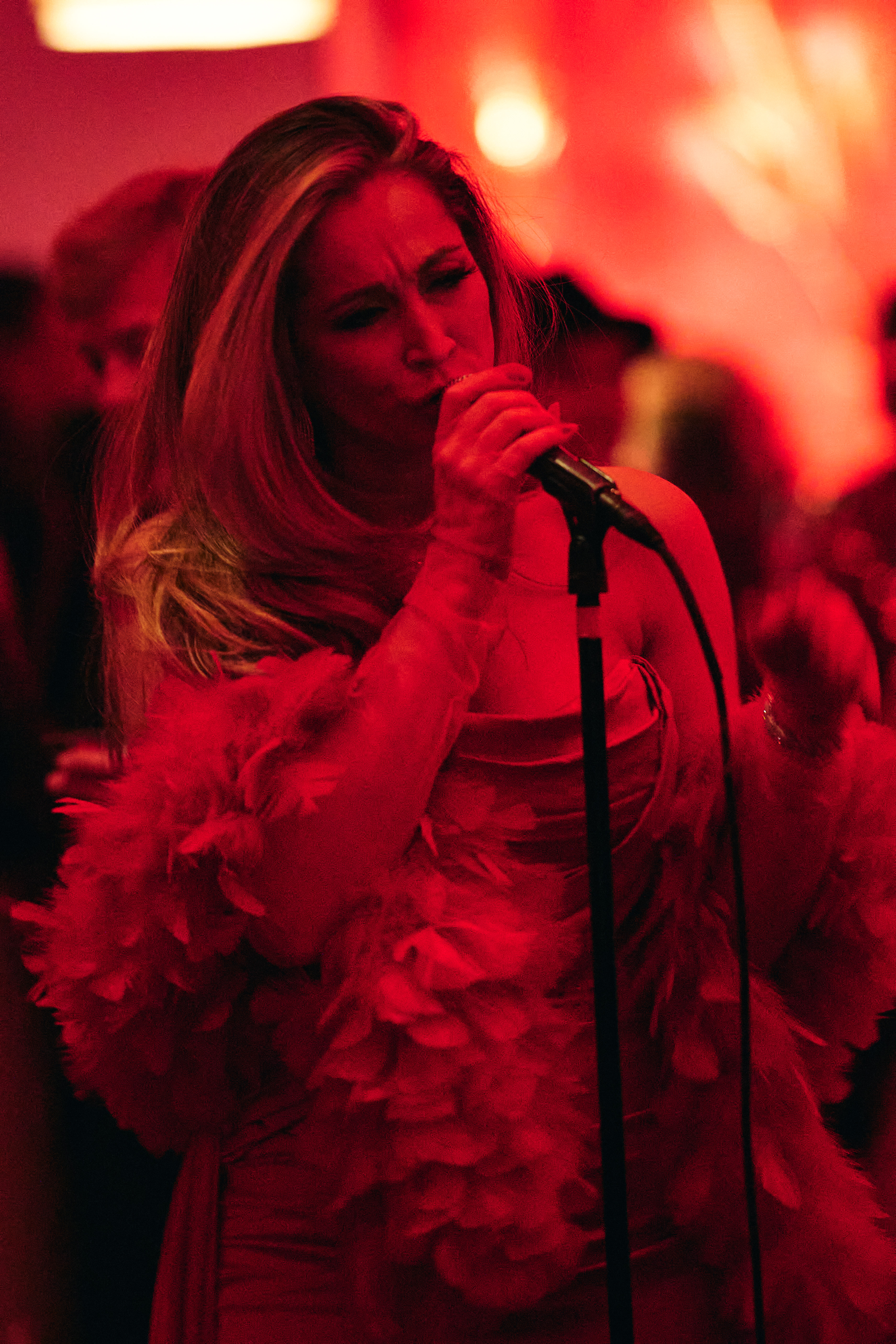 a person brushing the hair in front of a mirror posing for the camera