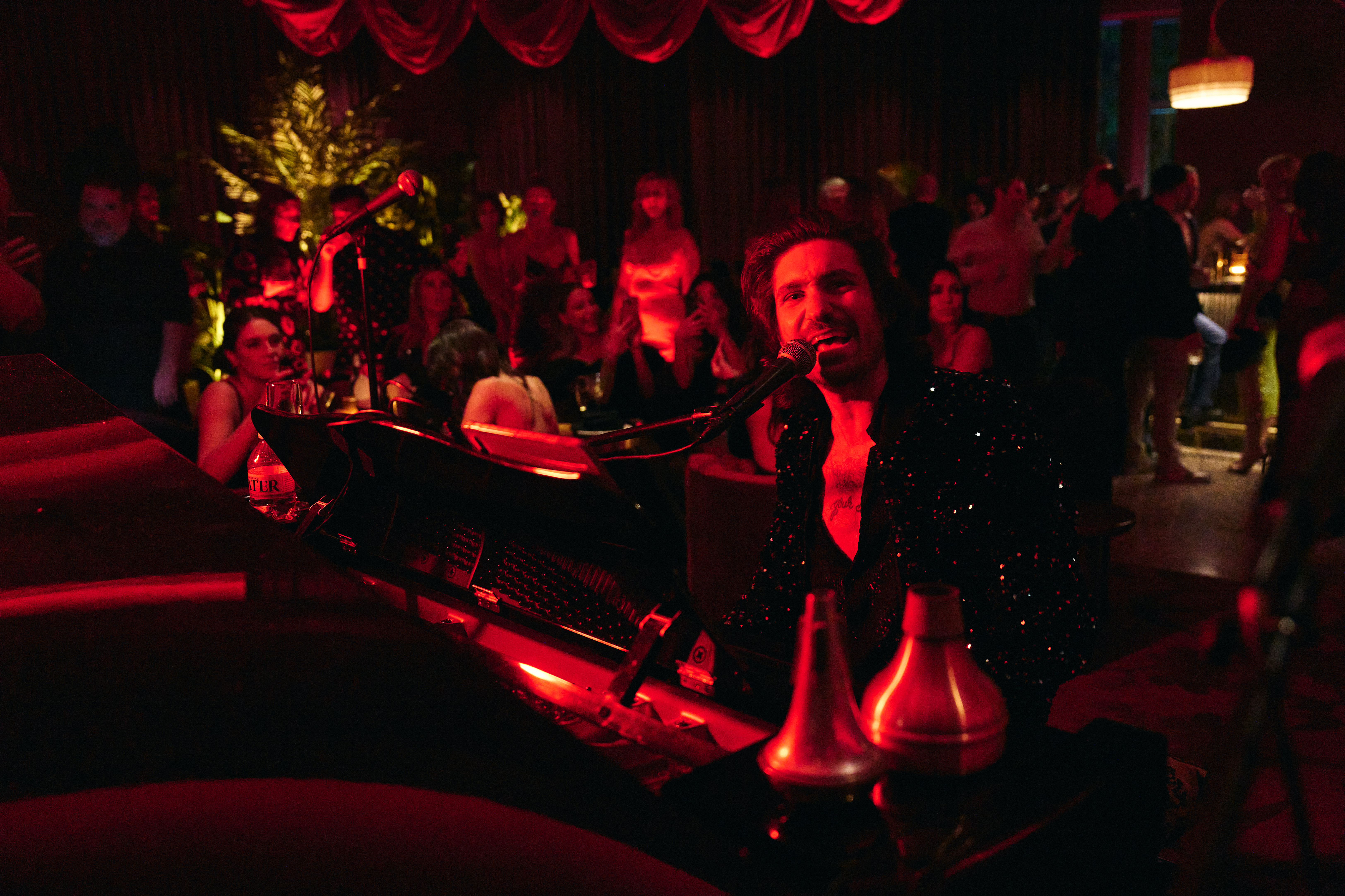 a group of people sitting at a table in a dark room