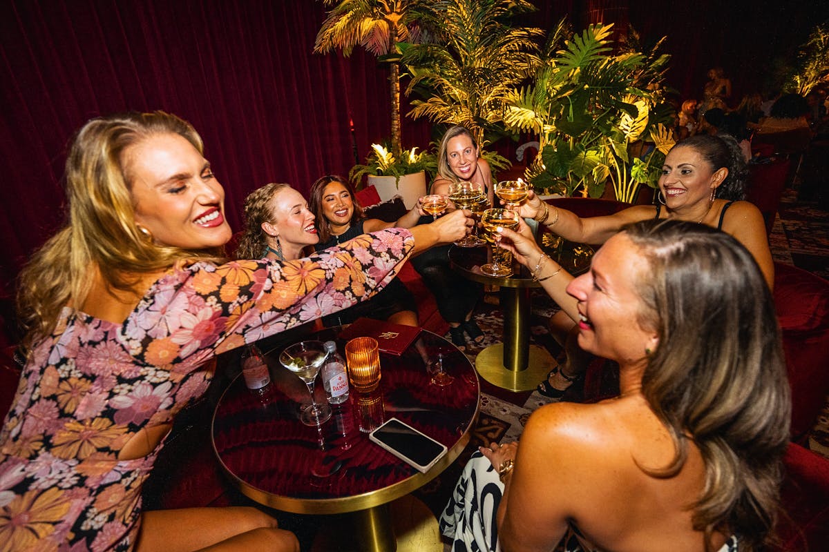 a group of people sitting at a table with wine glasses