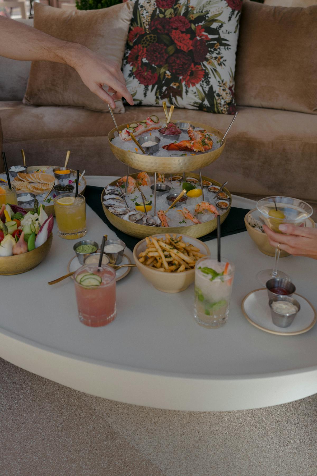 a person holding a plate of food on a table