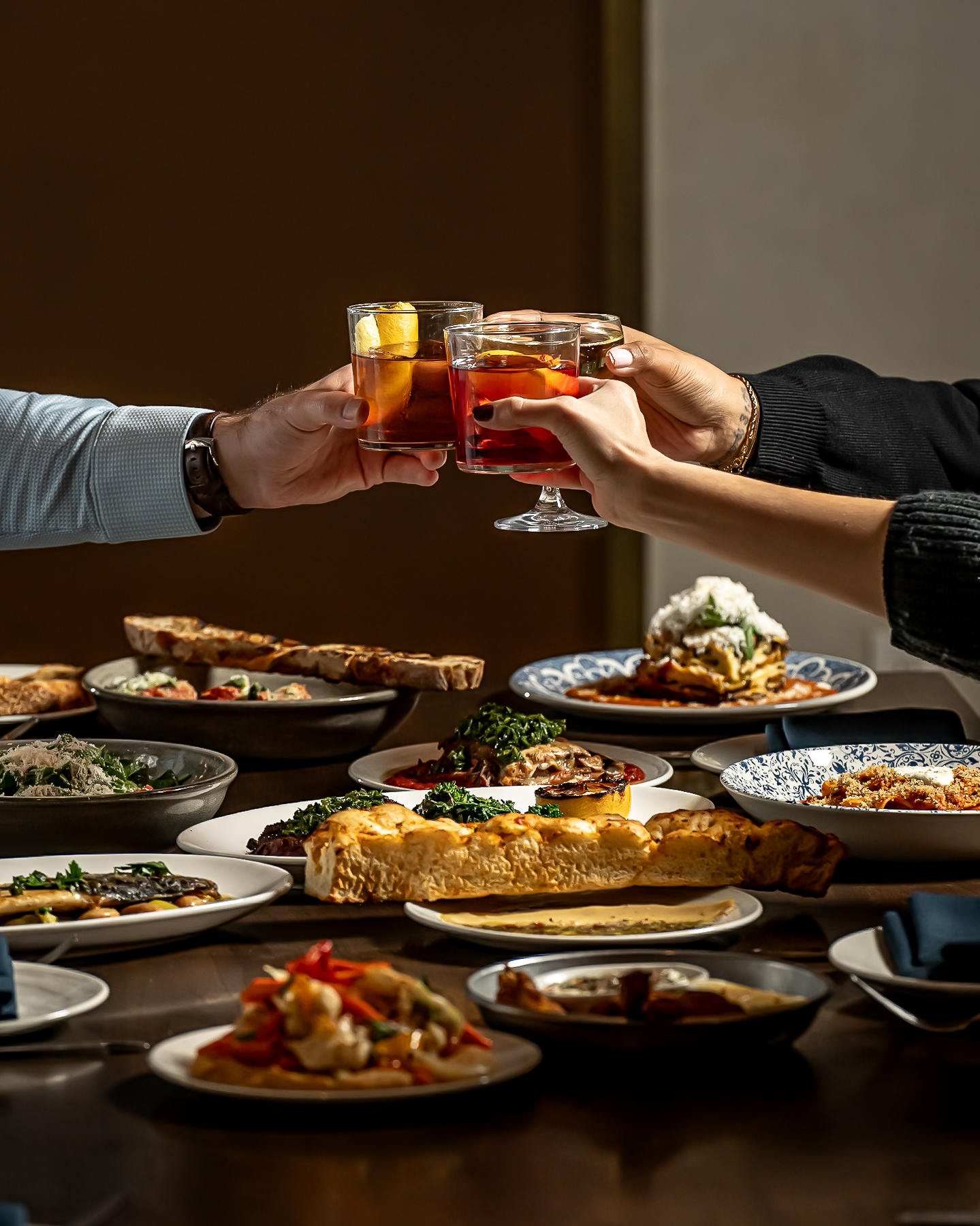 a woman sitting at a table with a plate of food