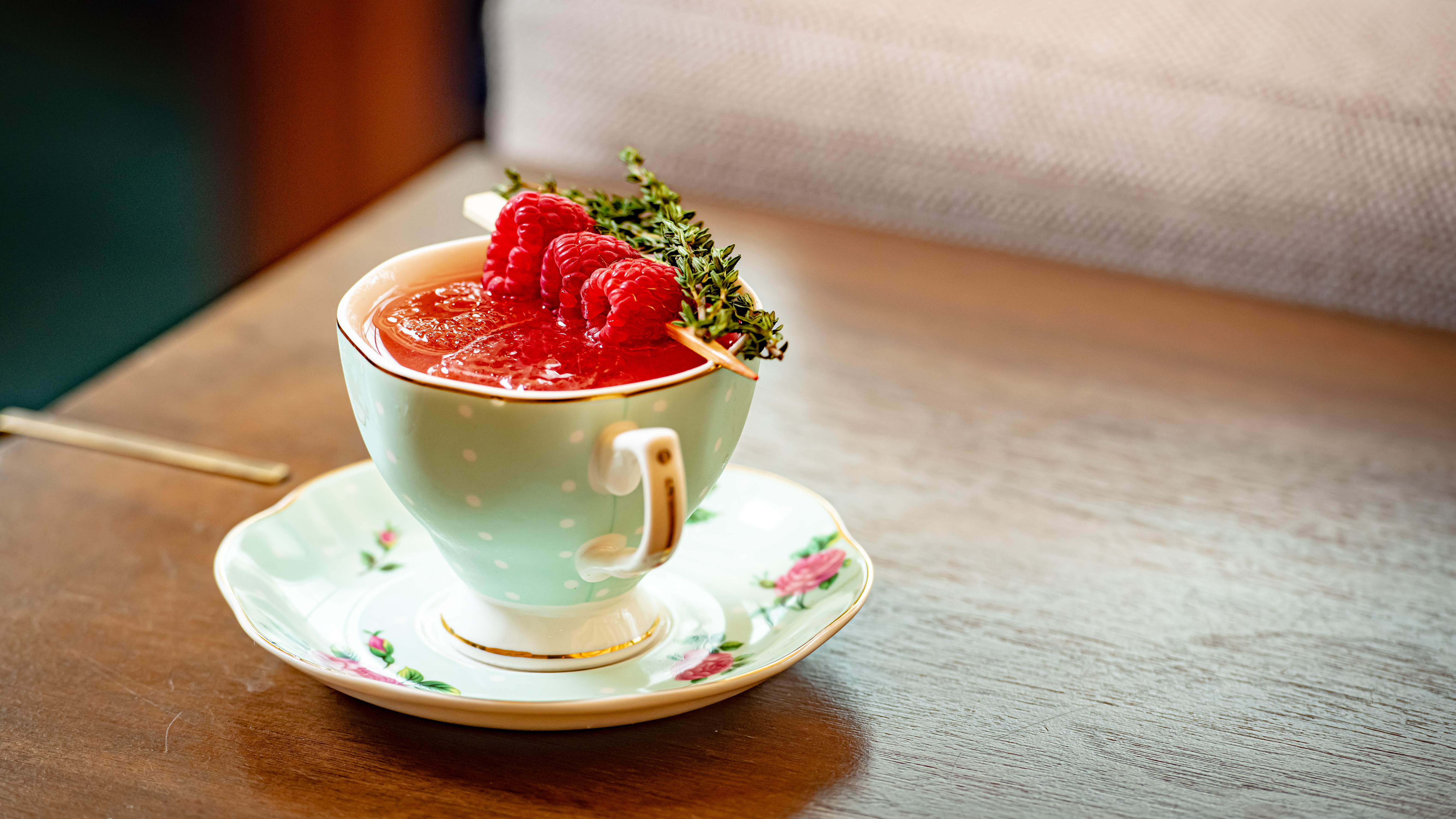 A cup of tea garnished with fresh strawberries on top, showcasing a delightful blend of flavors and colors