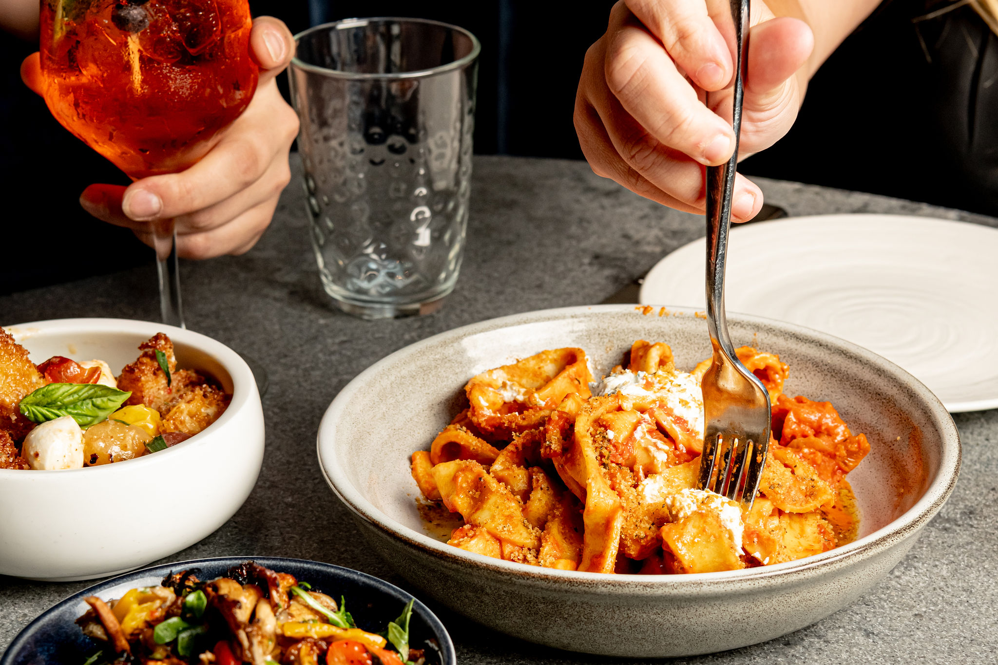 a person sitting at a table with a plate of food