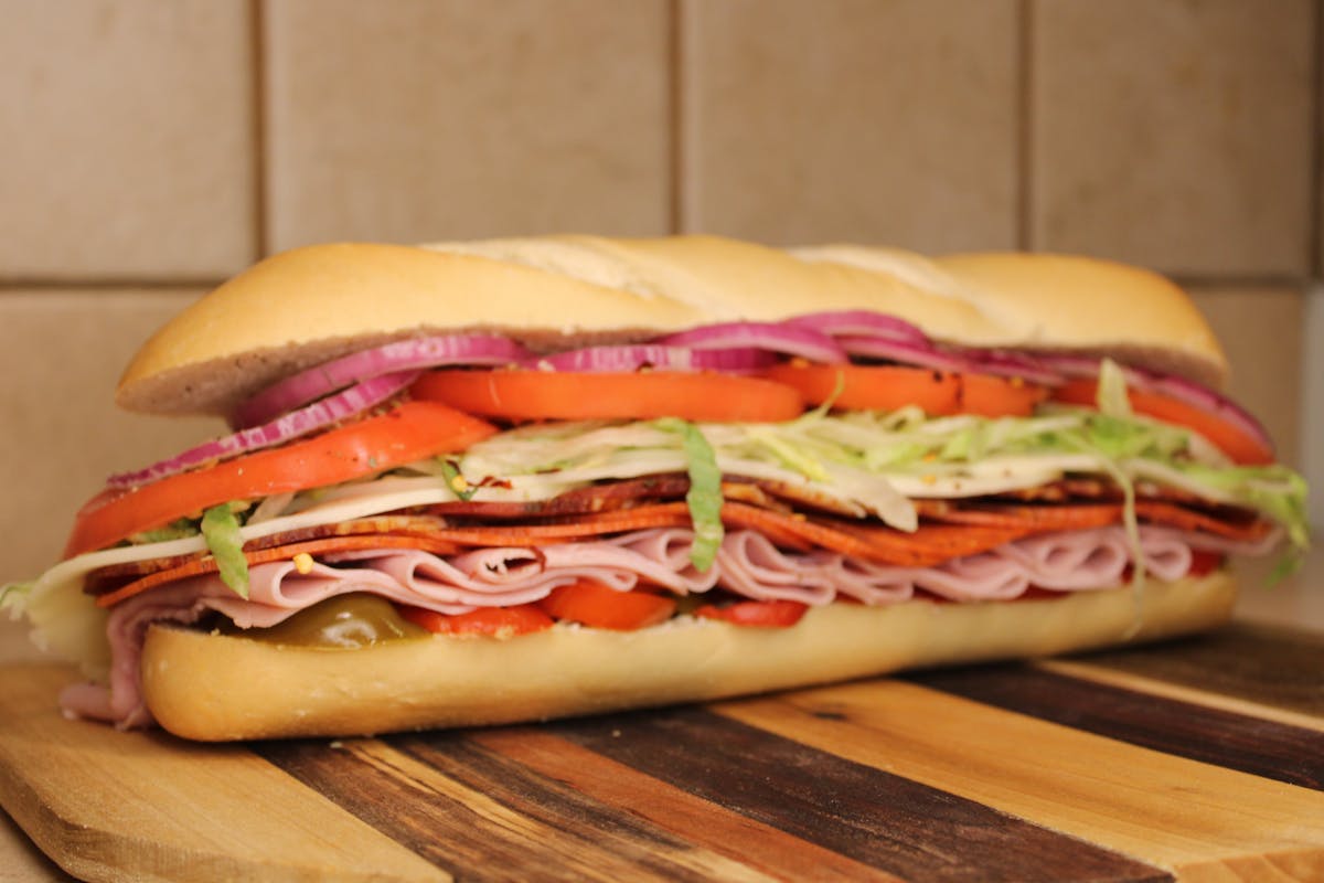 a close up of a sandwich sitting on top of a wooden table