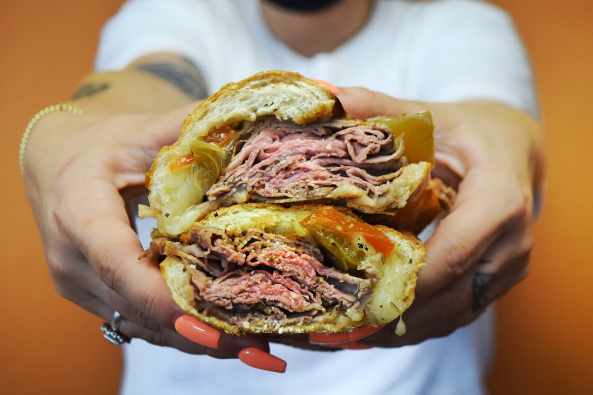 a hand holding a sandwich in portland oregon