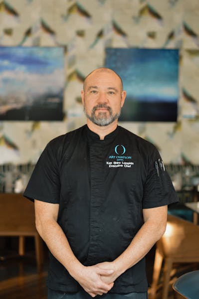 a man standing in front of a table