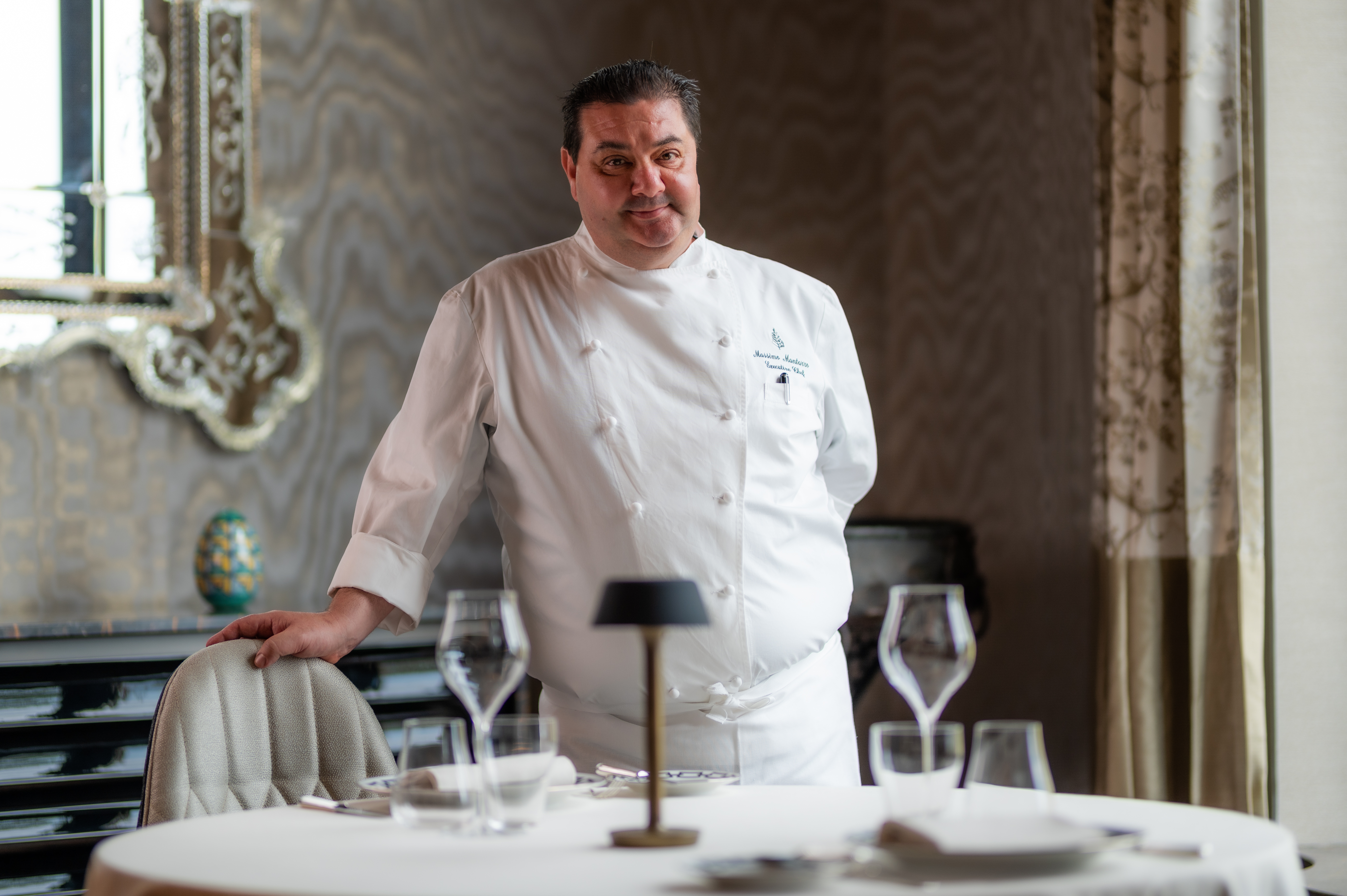 a person standing in front of a cake