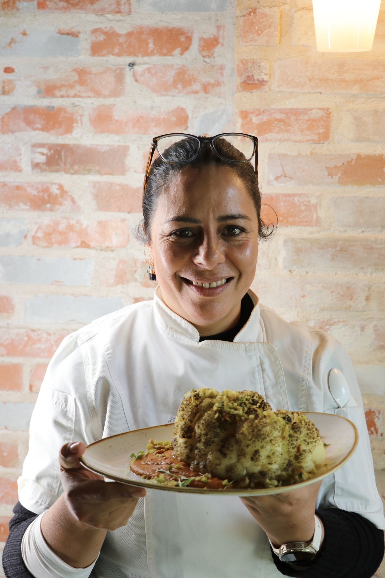a person sitting at a table with a plate of food