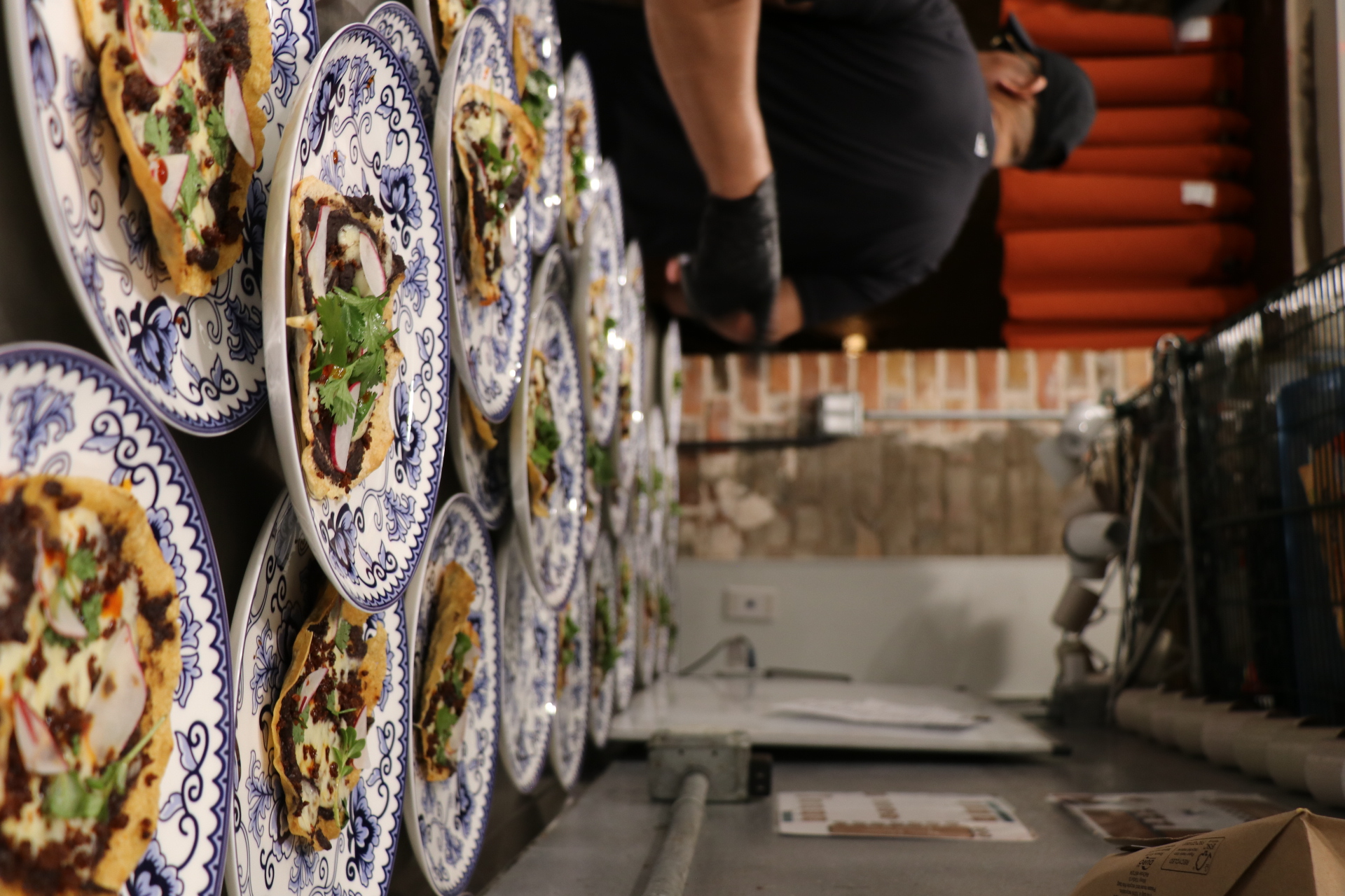 a person sitting at a table with a plate of pizza