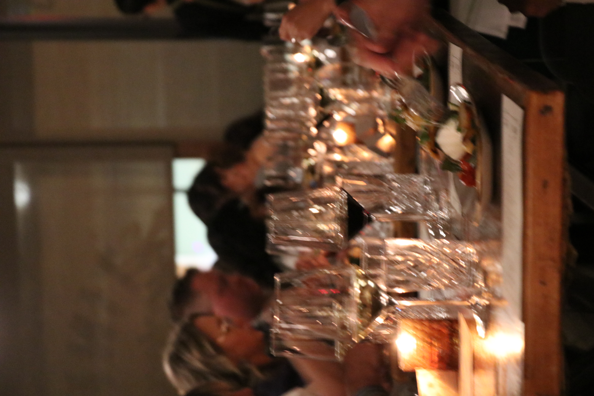 a group of people sitting at a table with wine glasses
