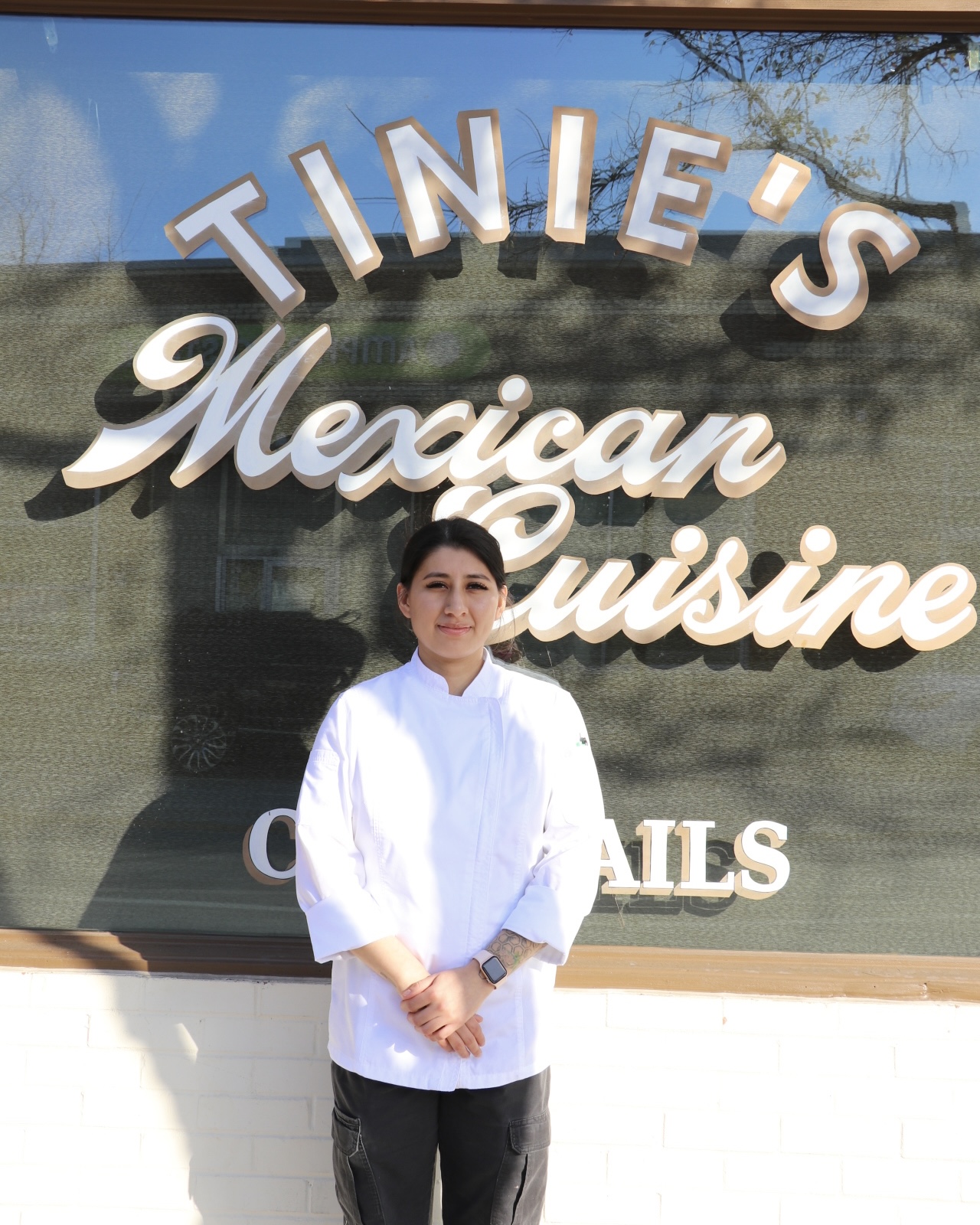 picture of a woman in front of a restaurant