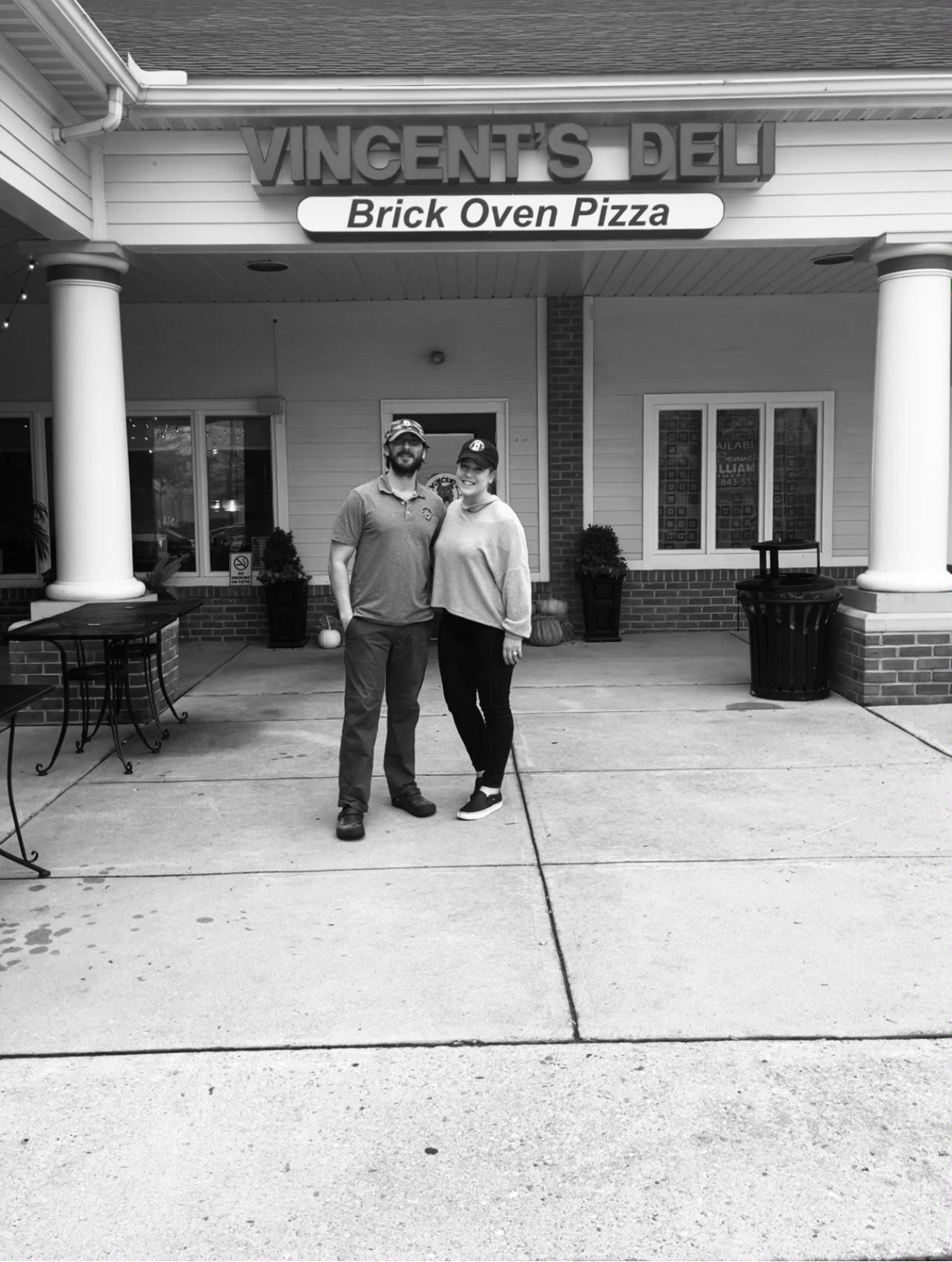 a man standing on a sidewalk in front of a building