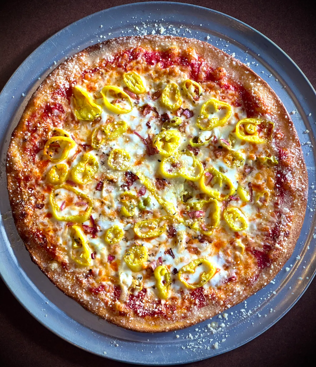 a pizza sitting on top of a pan on a table
