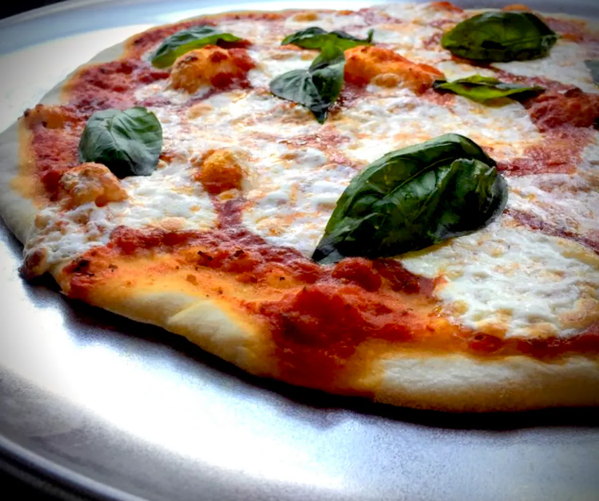 a pizza sitting on top of a plate of food
