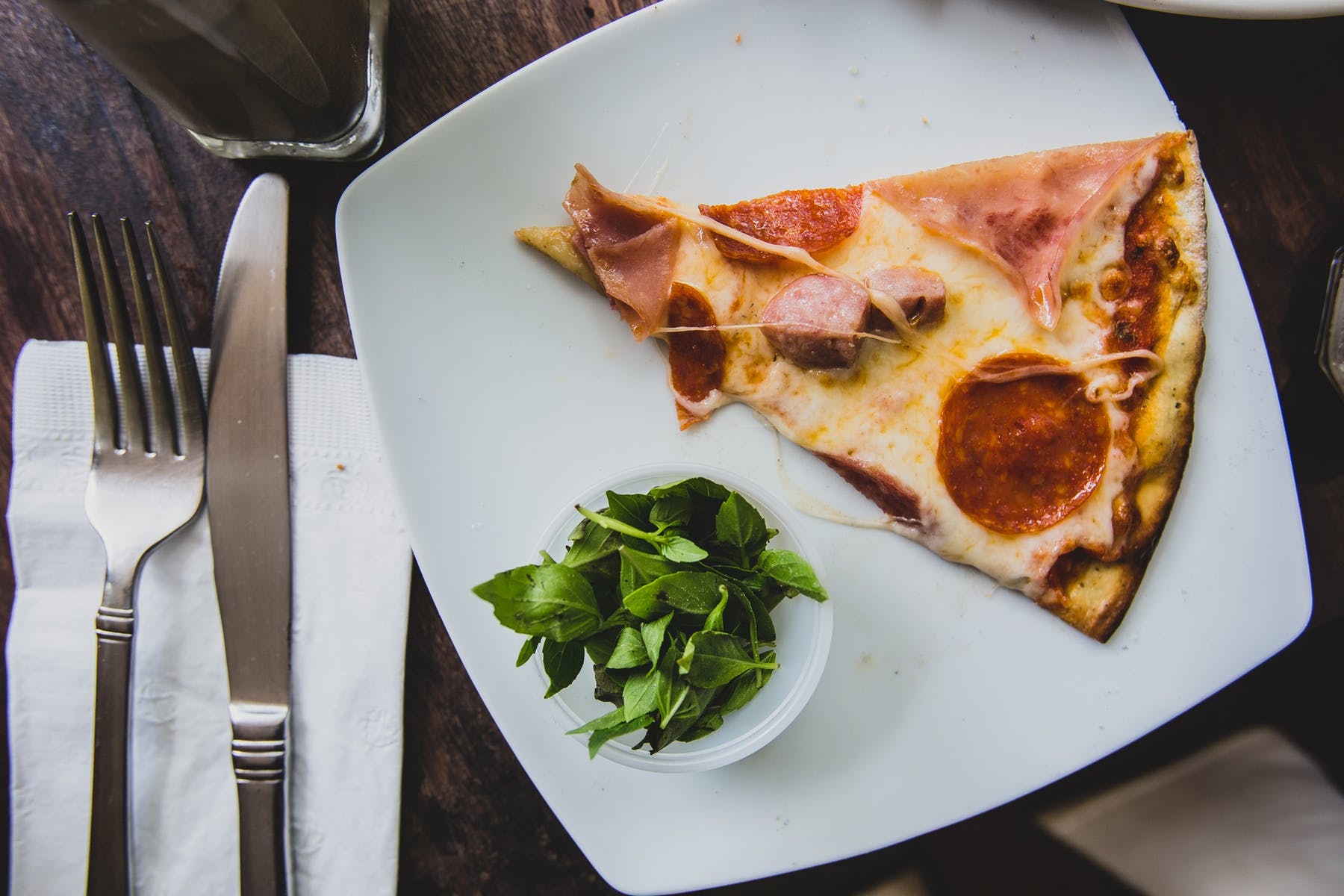 a plate of food with a slice of pizza