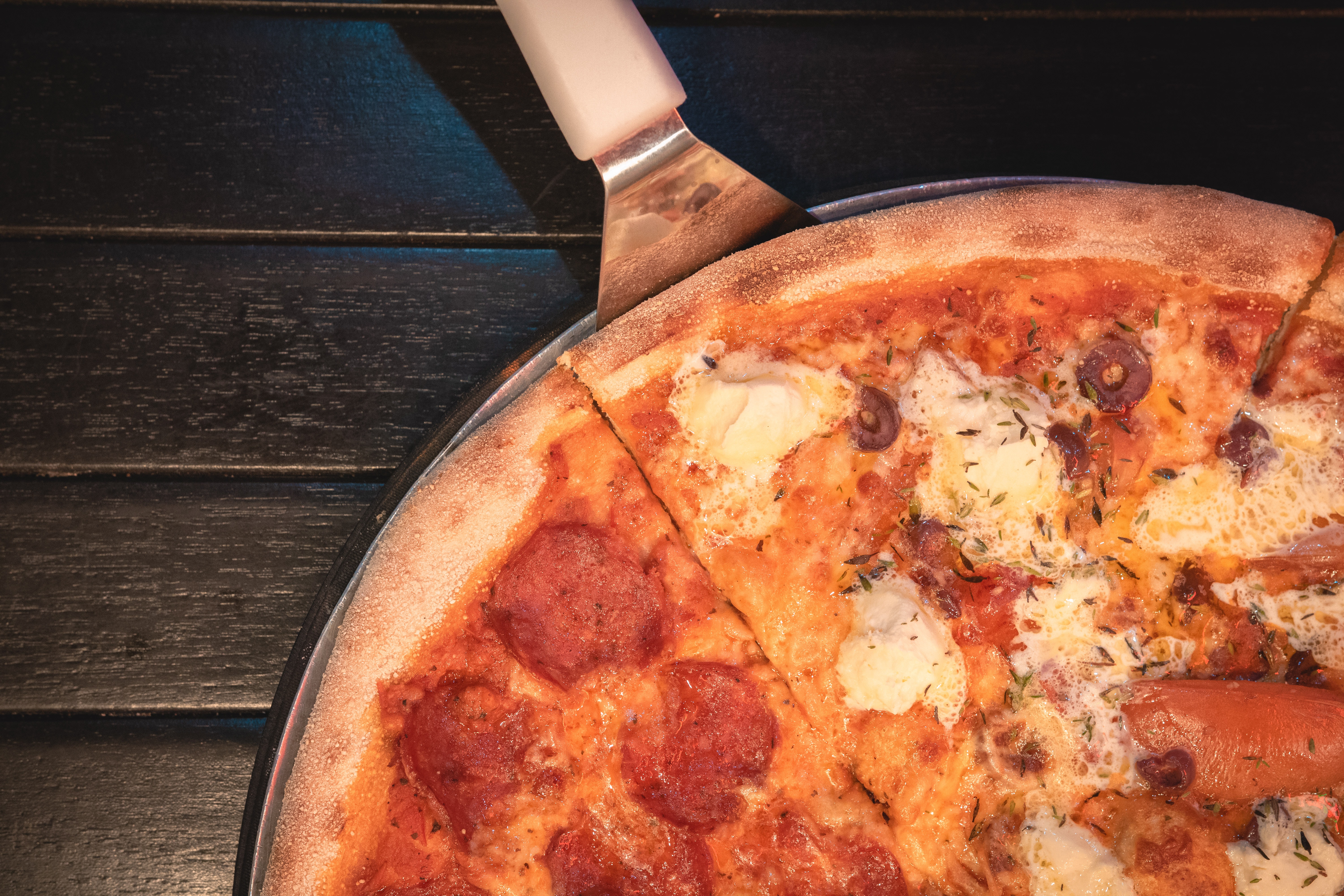 a pizza sitting on top of a pan on a table