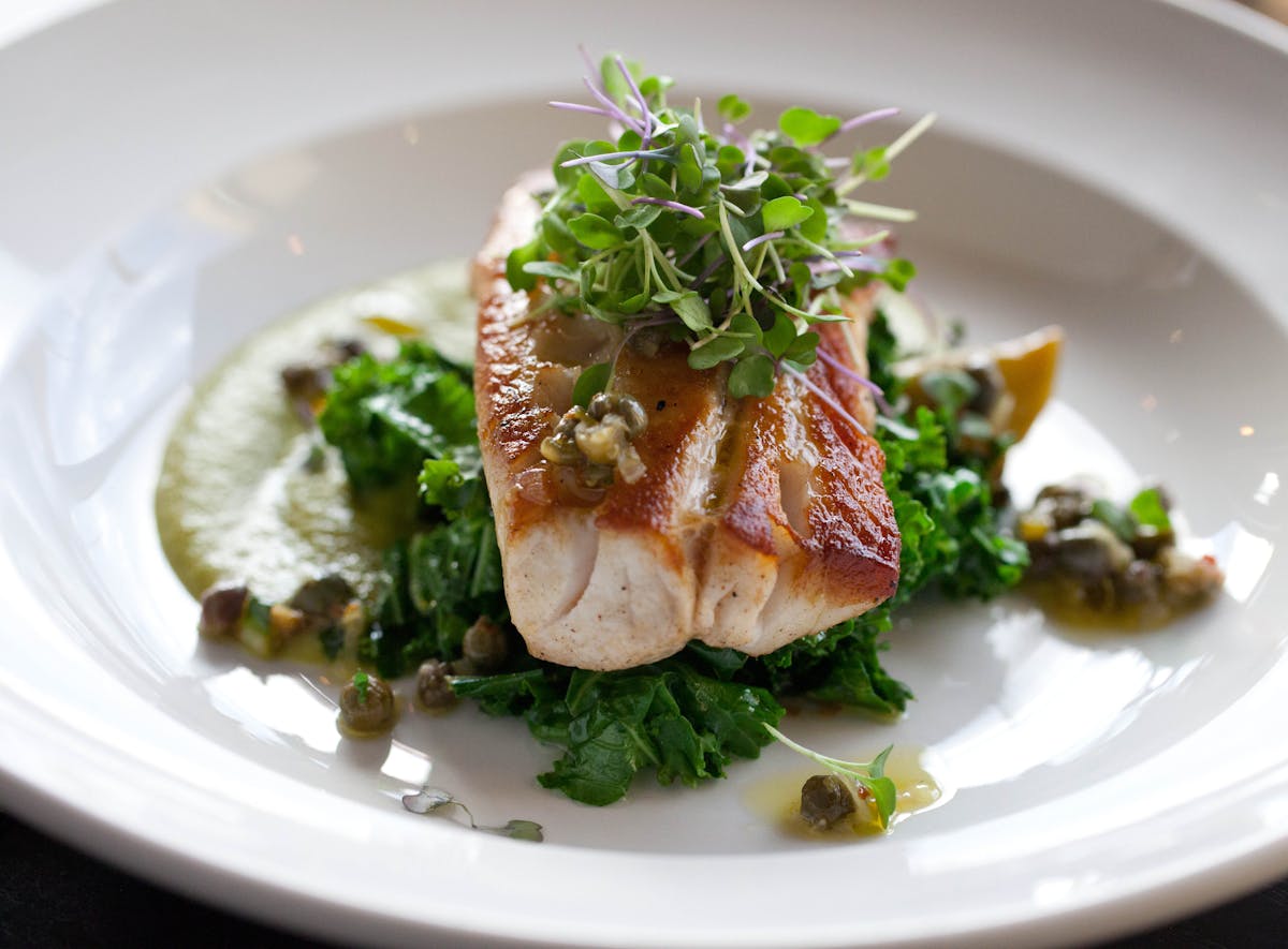 a white plate topped with meat potatoes and broccoli