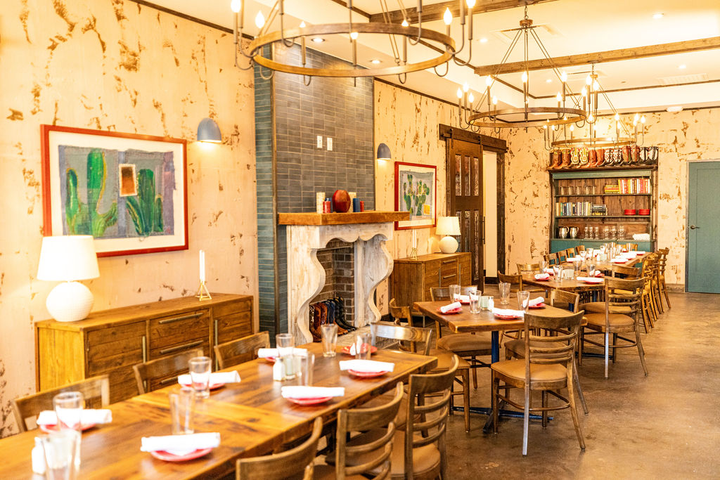 a room filled with furniture and a fire place and a dining table