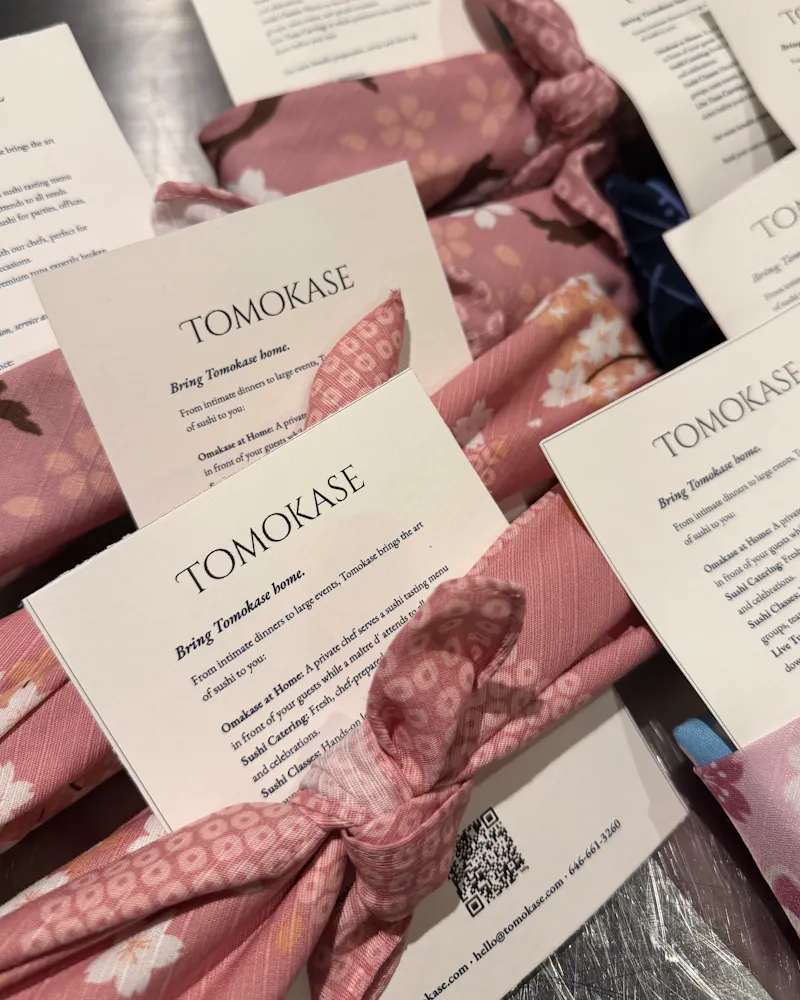 a group of folded fabric with cards tied together